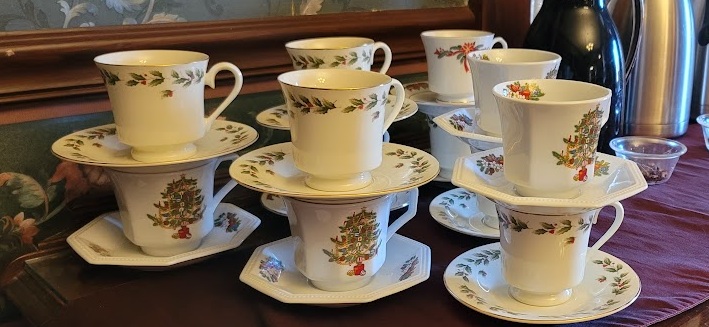 Old fashioned holiday teacups stacked on a buffet